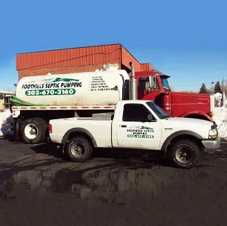 Foothills Septic Pumping trucks parked in winter snow